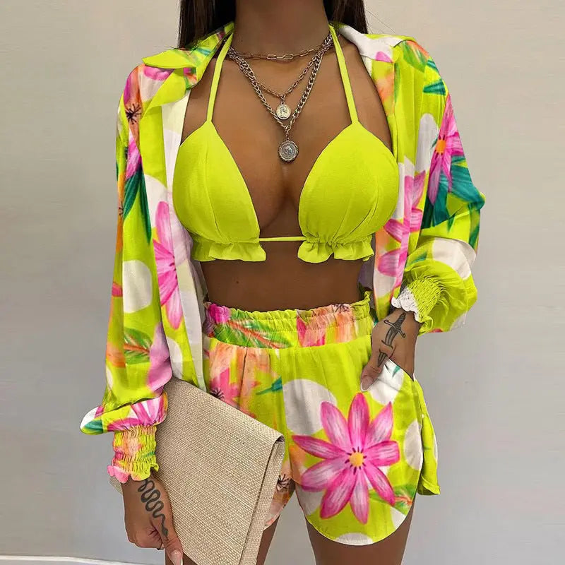 Women's swimwear: tropical floral bikini top, relaxed fit shorts & versatile beach cover-up for resort.