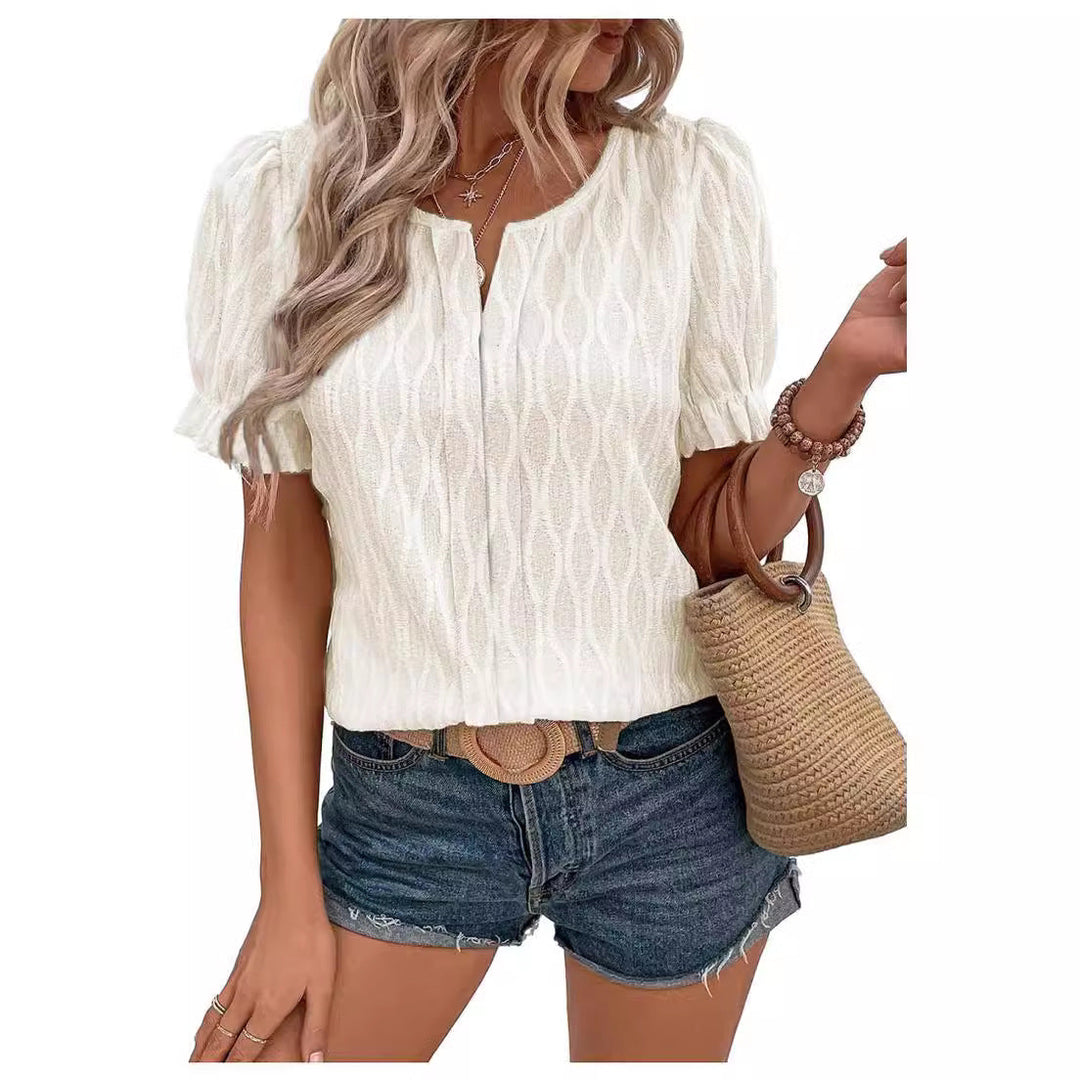 Close-up of elegant lace detail on the women's airy puff sleeve blouse, showing intricate design.