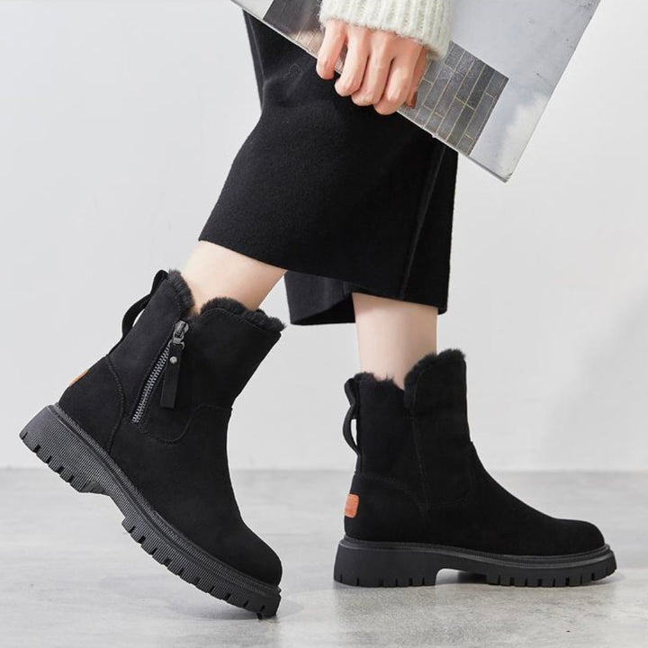 Stylish black women's winter boots, comfortable and non-slip for icy conditions.