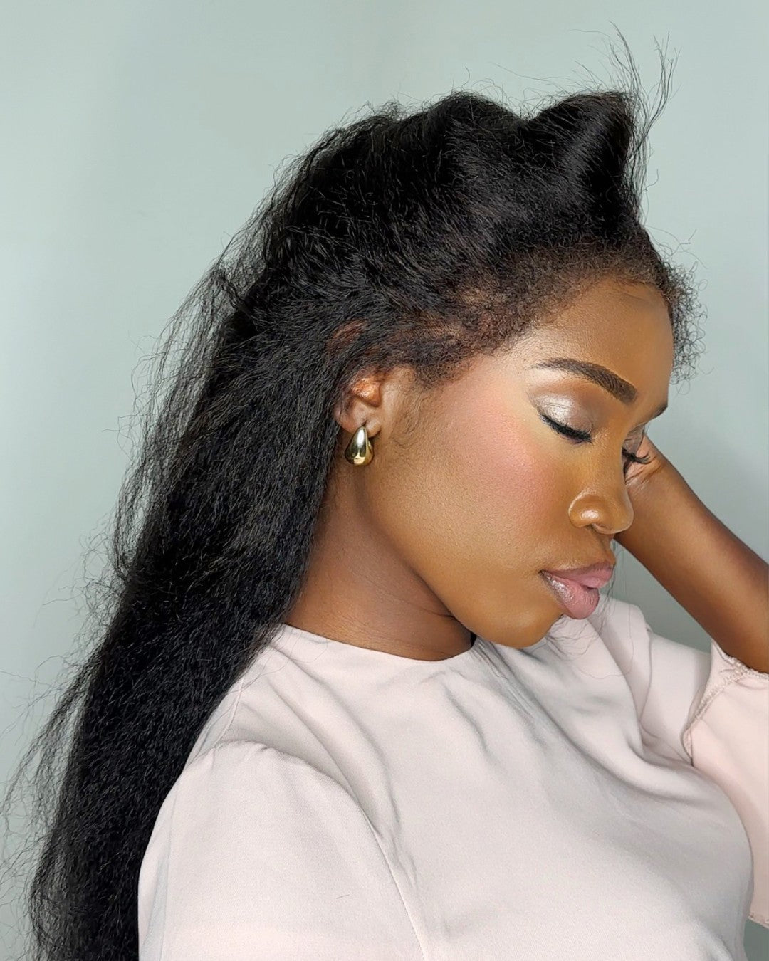 Elegant women's black HD lace wig, virgin human hair with natural curly edges for a stylish look.