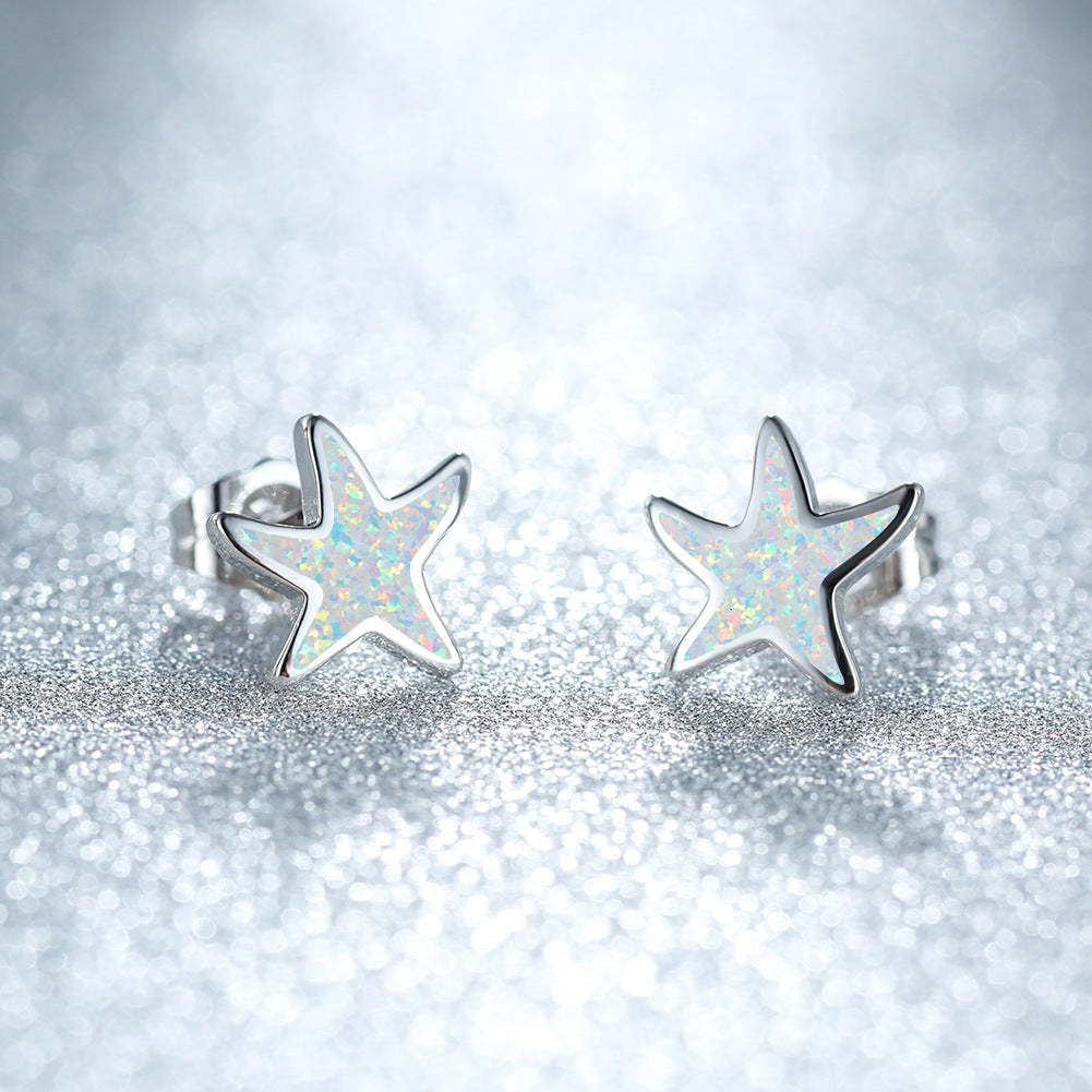 Women's rose gold blue opal starfish earrings, sparkling ocean-inspired gift.
