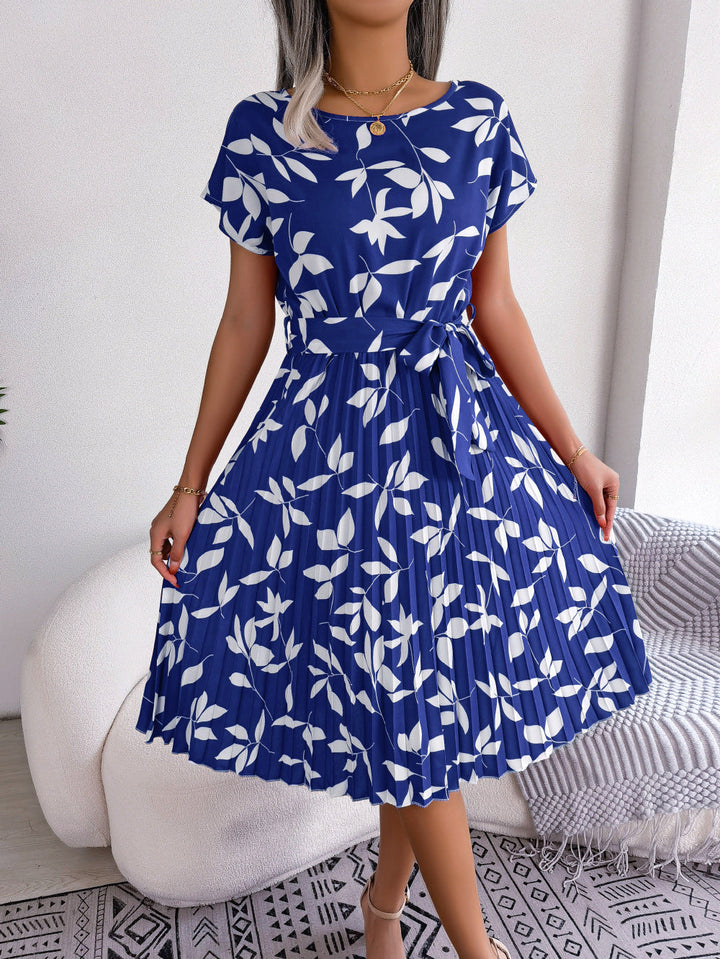 Women's blue printed midi dress with short sleeves, perfect for casual summer elegance. Versatile fashion.