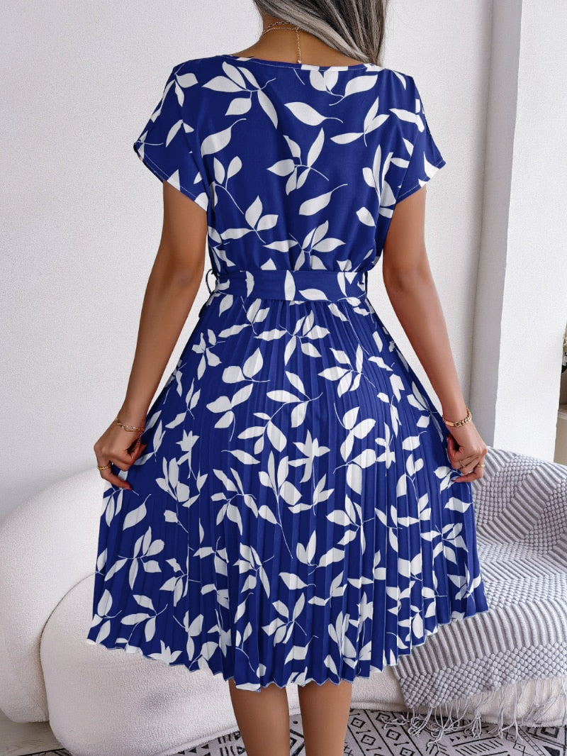 Model wearing elegant women's blue printed midi dress, ideal for effortless summer fashion and versatile styling.