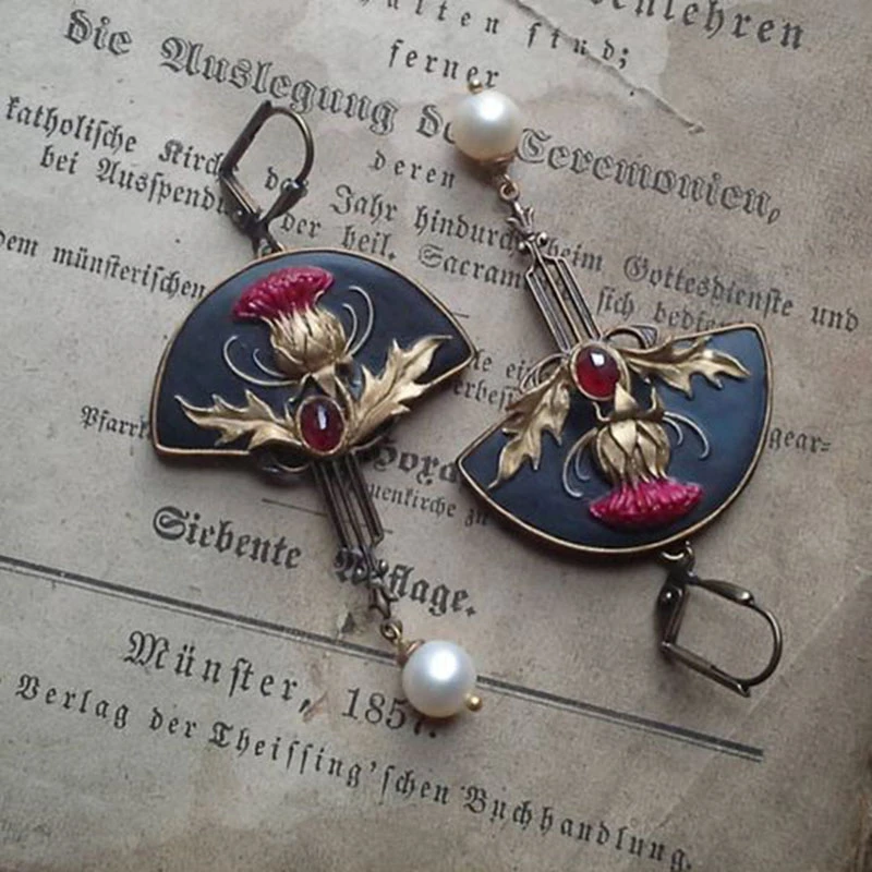 Women's boho dangle earrings with elegant pearls & sparkling red crystals. Fashionable statement jewelry.