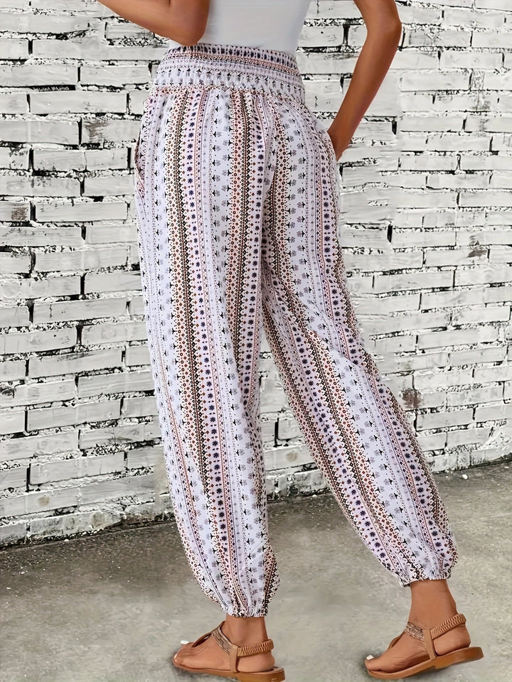 Casual women's printed pants with a high waist & smocked band, embodying bohemian summer style.