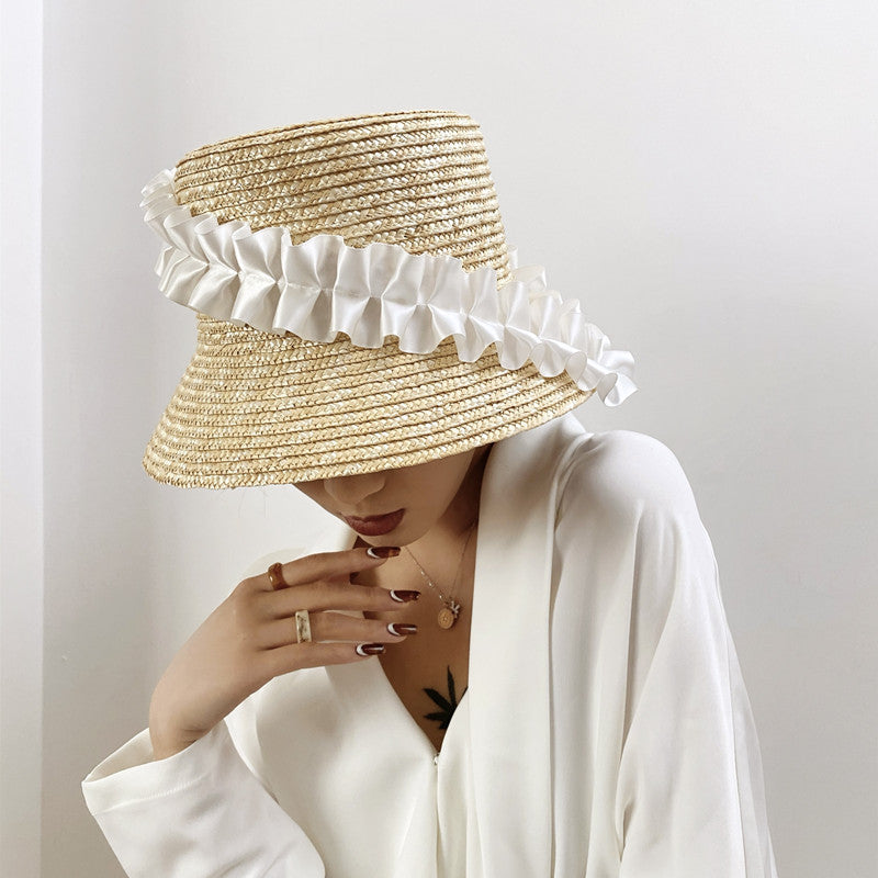 Braided straw bucket hat for women with stylish khaki stripes, great for beach or casual summer wear.