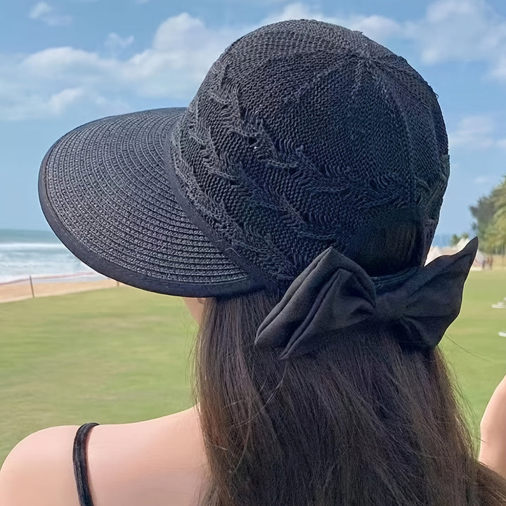 Fashionable women's straw-braided sun hat featuring a delicate bow, ideal for summer beach days.