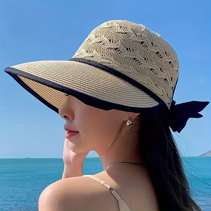 Fashionable women's sun hat, braided and breathable, with a delightful bow for summer style.