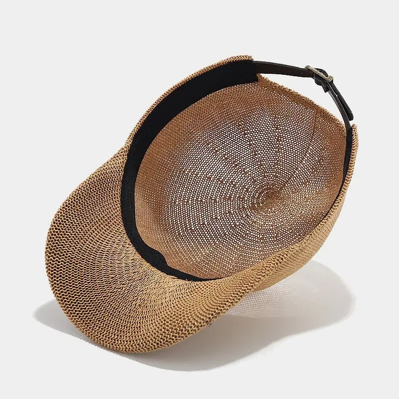 Close-up of a women's braided summer hat with a wide brim, showcasing texture.