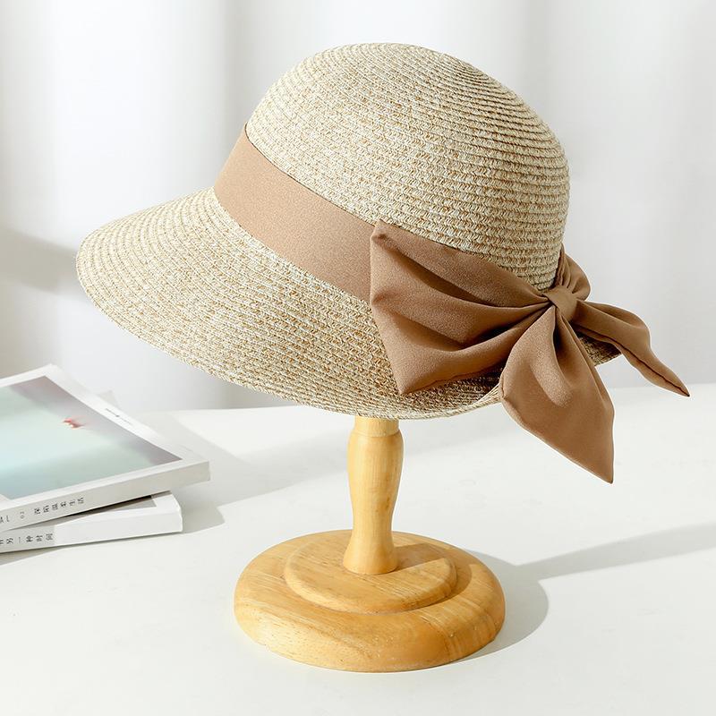 Stylish women's wide-brim sun hat with a decorative bow, offering excellent sun protection for gardening or travel.