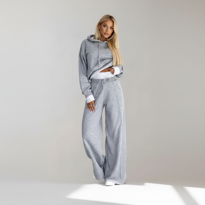 Full-body shot of a comfortable women's two-piece casual outfit, hoodie and wide-leg pants, for leisure.