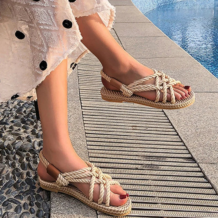 Chic black women's braided gladiator sandals, offering ultimate comfort as flat summer footwear for beach & vacation.