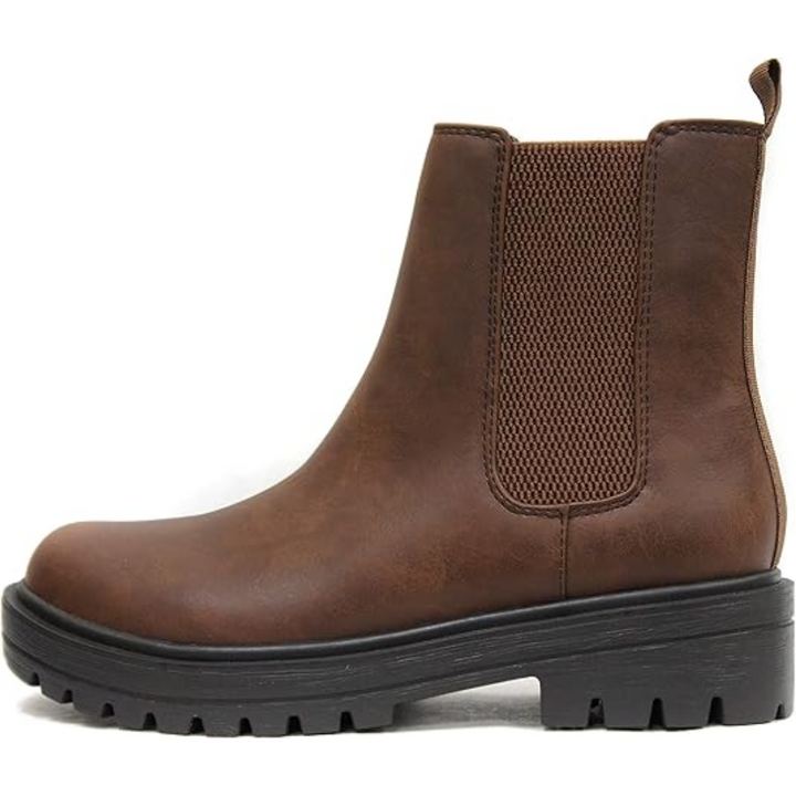 Close-up of the elastic side panel on chic women's low heel Chelsea ankle boots.