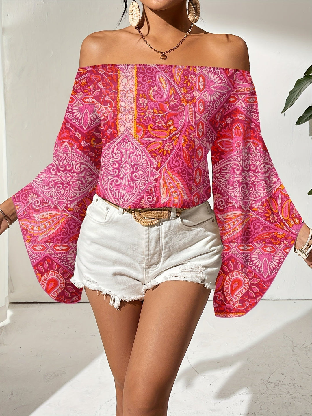 Trendy feminine off-shoulder blouse with a chic geometric print and comfortable fit.