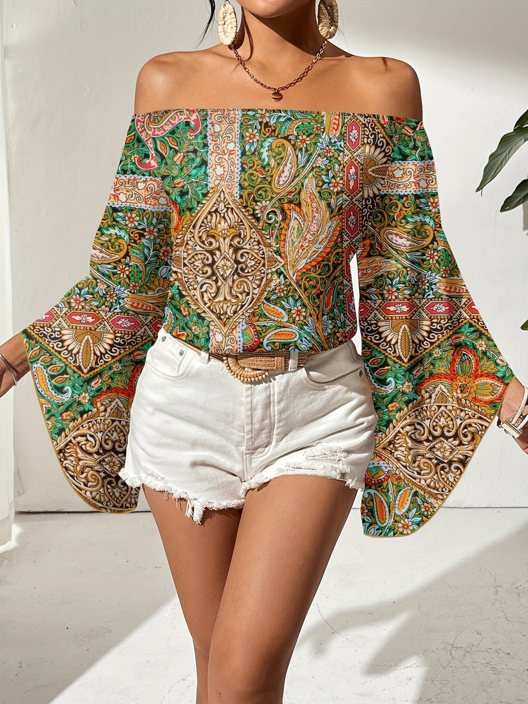 Elegant women's off-shoulder blouse with a modern geometric print, suitable for various occasions.
