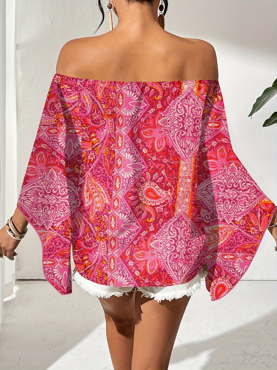 Chic off-shoulder blouse for women with vibrant geometric print and stylish flared sleeves.