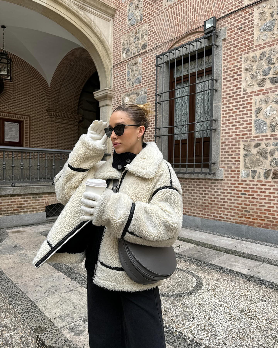 Cozy women's oversized teddy aviator jacket, a warm and stylish winter outerwear piece in cream.