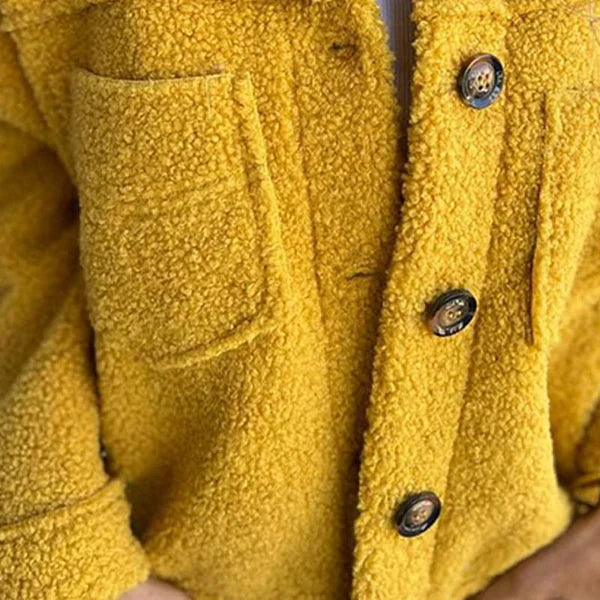 Women's cozy short teddy coat featuring a chic lapel and button closure. Ideal for casual fall/winter wear.