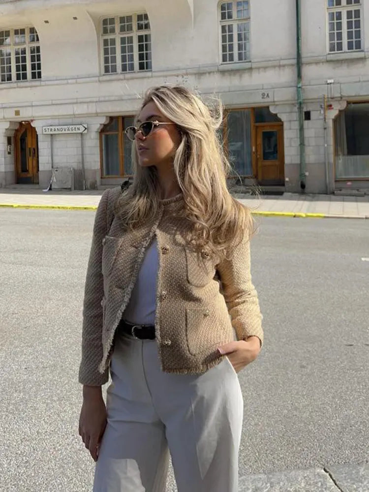 Timeless beige tweed jacket for women. Versatile chic outerwear with gold buttons, suitable for any elegant style.