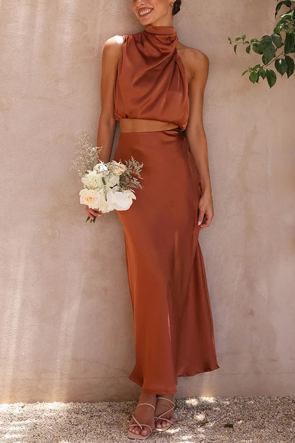 Elegant women's two-piece outfit with an asymmetric neckline sleeveless top & flattering skirt.