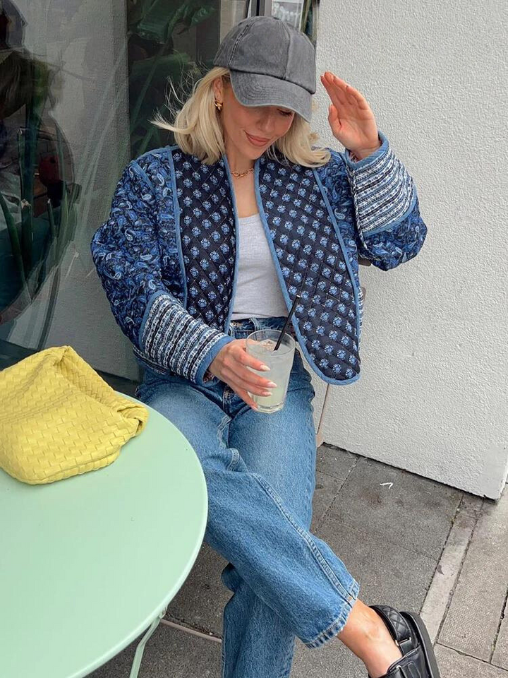 Elegant women's jacket featuring intricate floral patchwork in a classic vintage style. Chic fashion outerwear.