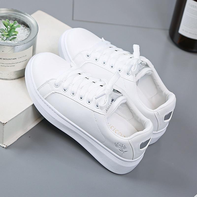 Comfortable white women's sneakers with elegant metallic details, ideal for casual wear or office style.