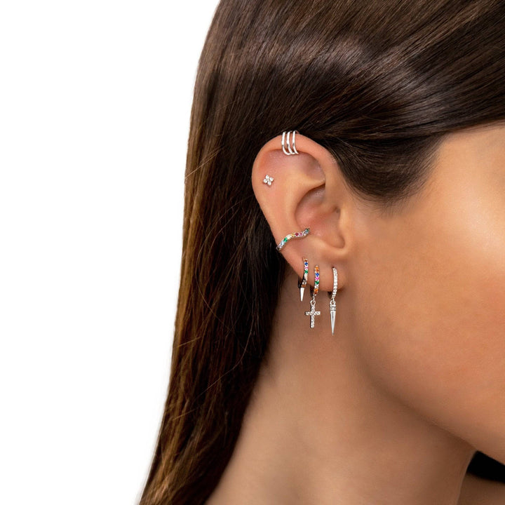 Close-up of women's gold plated dangle earrings with colorful zirconia cross design, sparkling elegant spiritual gift.