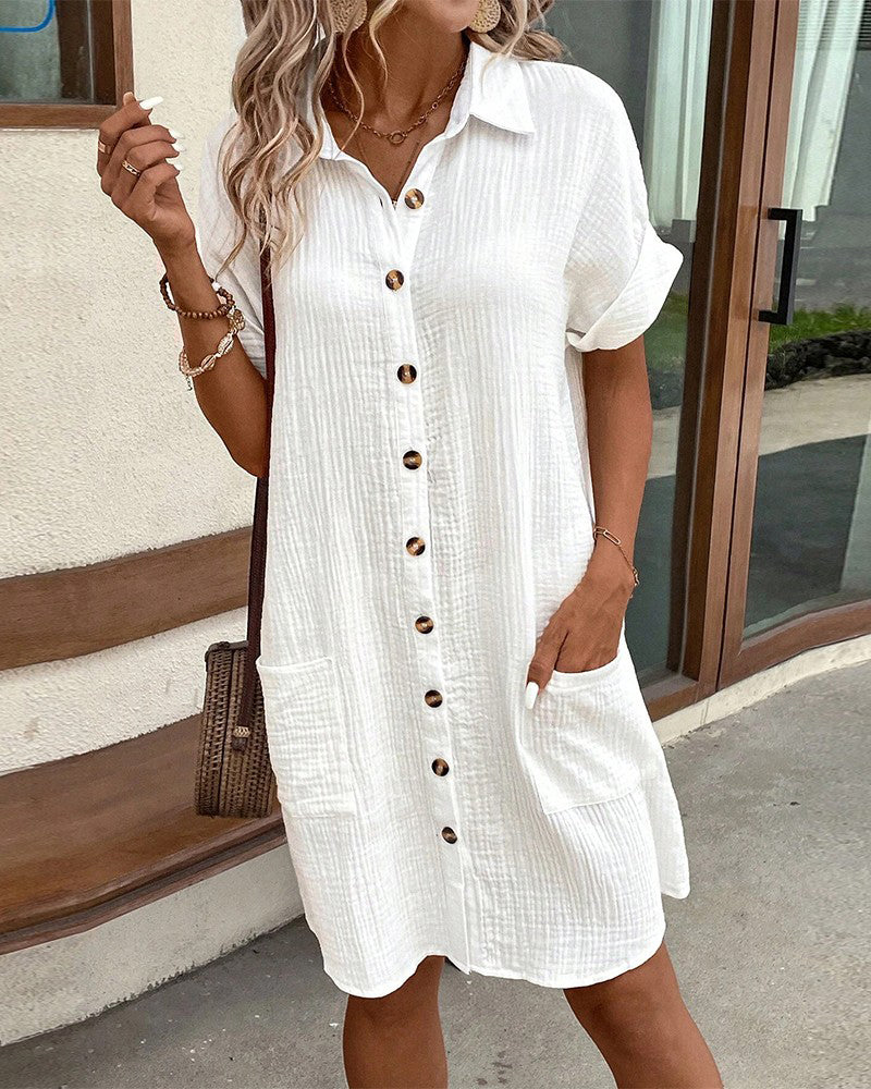 Trendy women's summer dress featuring short sleeves & full button closure. Essential for warm weather fashion.