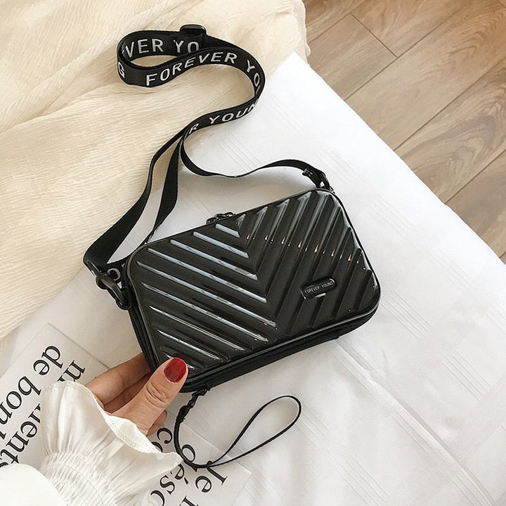 Stylish women's hard shell mini bag, perfect for daily use. Protective vegan leather with secure zip.