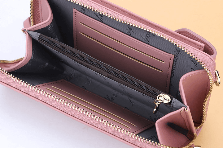 Detail of the zipper closure on a compact women's PU leather crossbody bag adds security
