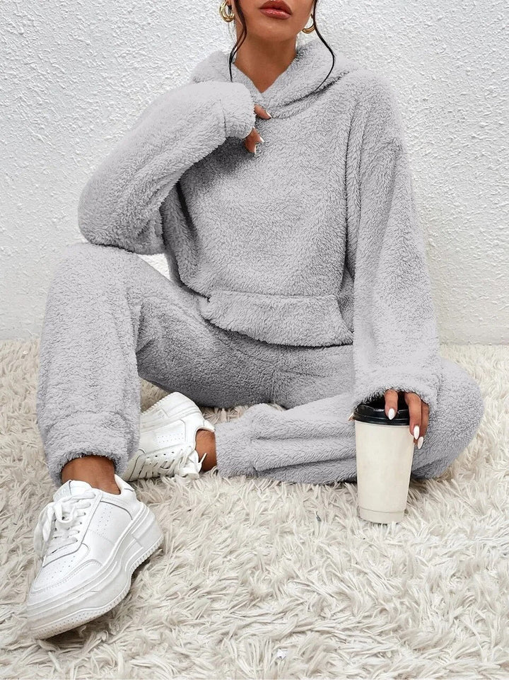 Women's luxurious hooded teddy loungewear. Soft fabric, perfect two-piece for relaxation & comfort.