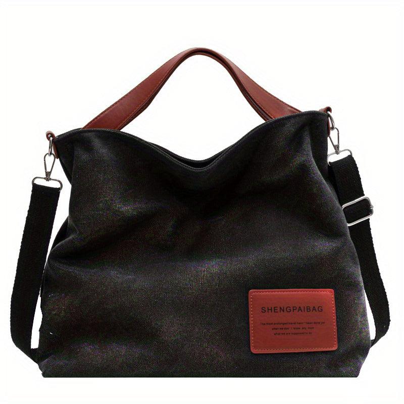 Stylish women's canvas shoulder bag in black, versatile and durable for all your everyday needs.