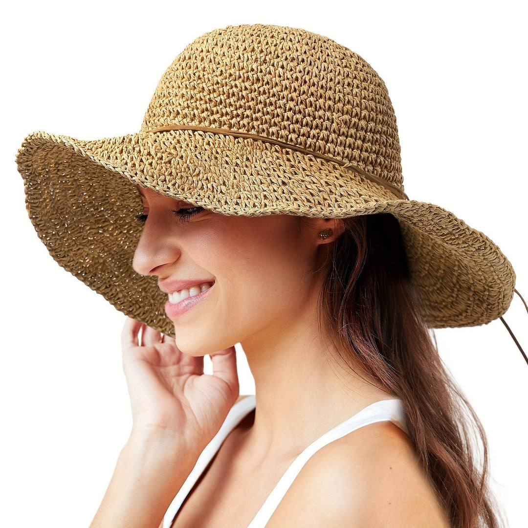 Close-up of the intricate crochet pattern on a women's boho straw summer hat.