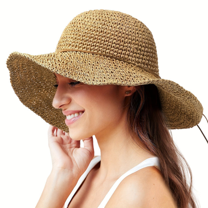 Close-up of the intricate crochet pattern on a women's boho straw summer hat.
