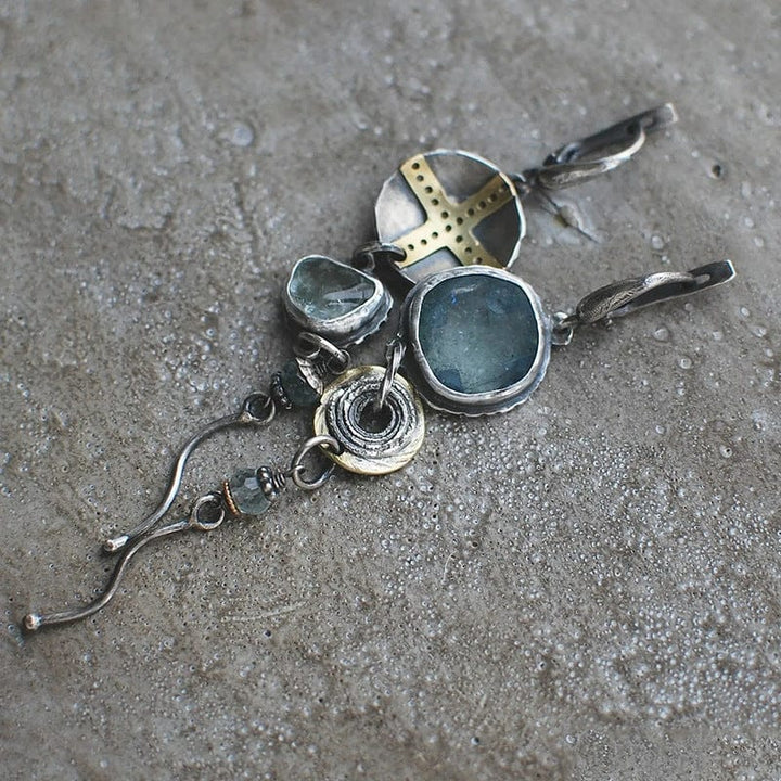 Women's elegant blue gemstone cross dangle earrings, a stunning piece of symbolic faith jewelry.