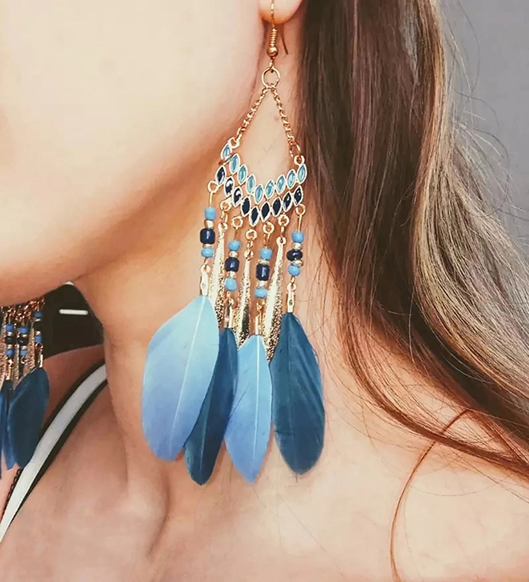 Women's elegant feather dangle earrings, perfect for a chic look. Gold plated and hypoallergenic.