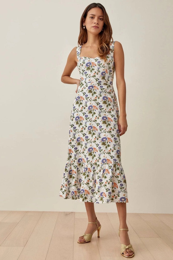 Women's elegant floral flared midi dress with delicate straps, perfect for summer days.