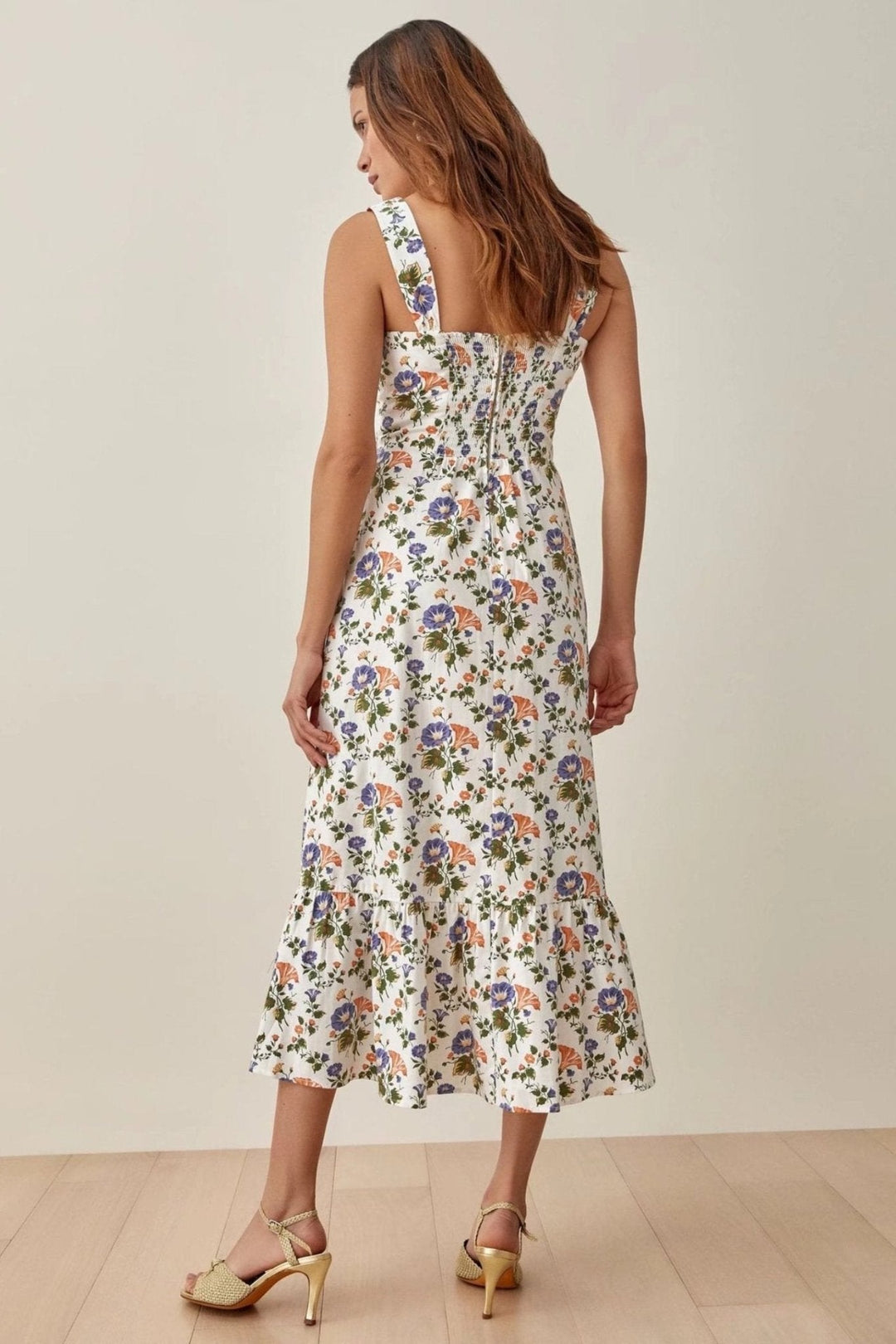 Vibrant women's floral midi dress, flared and strappy, offering a graceful and elegant look.