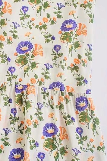 Elegant women's floral print flared midi dress with thin straps, a versatile summer daywear option.