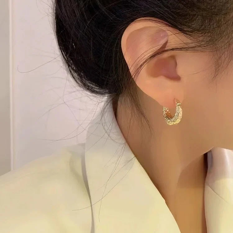 Women's elegant gold hoop earrings, perfect for classic styling & versatile accessorizing.