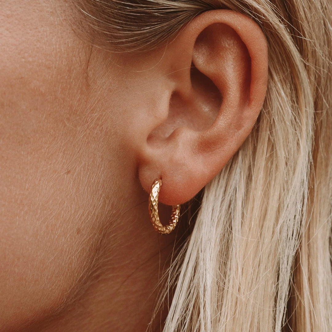Women's elegant hammered gold hoop earrings, perfect for daily wear.
