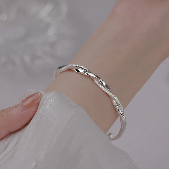 Women's elegant sterling silver bracelet with intricate design, a timeless jewelry accessory.
