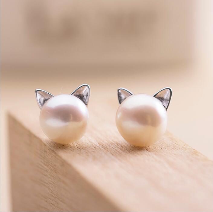 Stylish women's sterling silver cat earrings, featuring a pearl accent. Perfect animal stud jewelry.