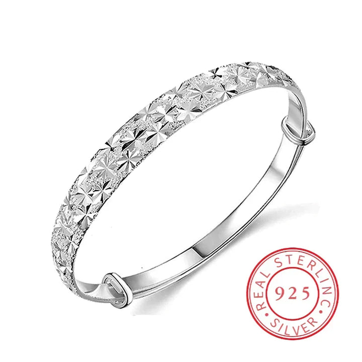 Women's elegant sterling silver star charm bracelet, adjustable, delicate everyday wear.