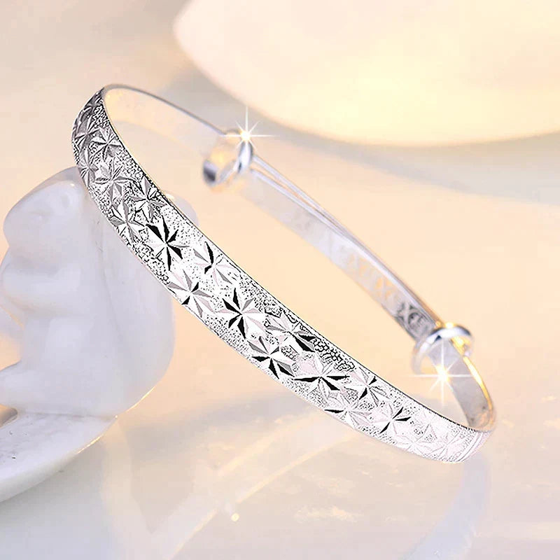 Elegant adjustable sterling silver women's bracelet with a charming star pendant.