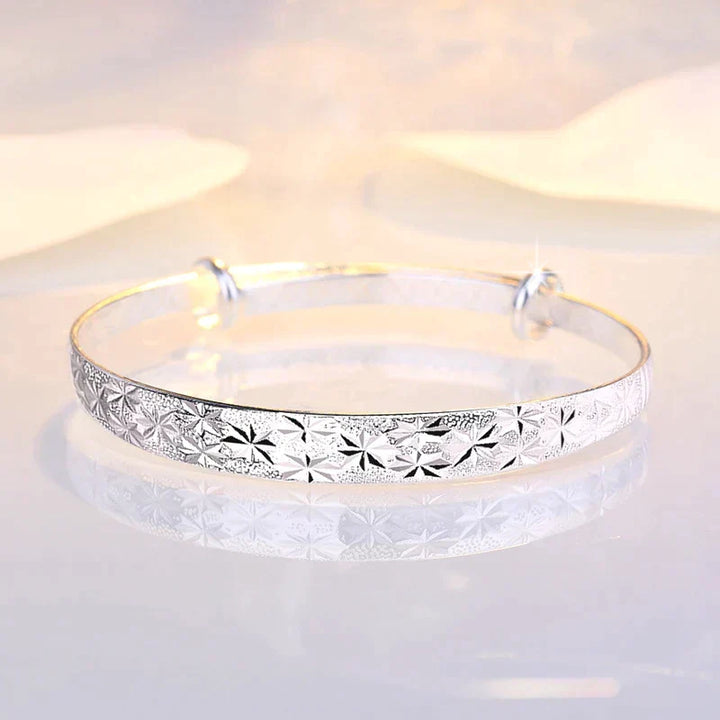 Shining star charm on an adjustable sterling silver women's bracelet. Elegant & versatile.
