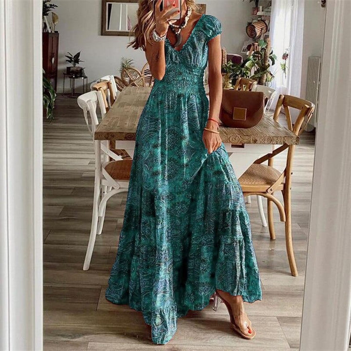 Side view of the women's long V-neck maxi dress with ethnic print, highlighting its elegant drape.