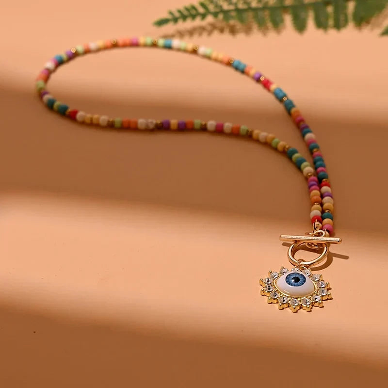 Trendy women's pearl choker necklace featuring an evil eye for style, protection, and good luck.