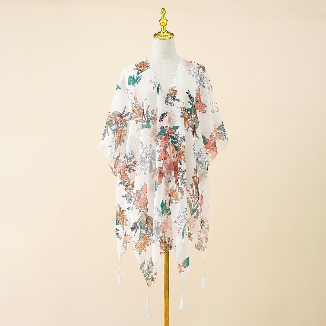 Stylish women's swimwear kimono cover-up, adorned with a beautiful floral print and playful tassels.