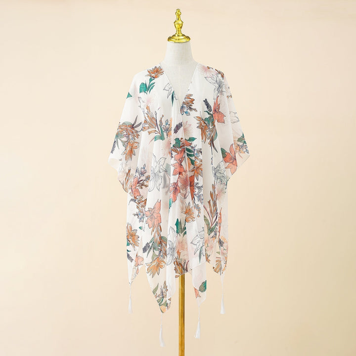 Stylish women's swimwear kimono cover-up, adorned with a beautiful floral print and playful tassels.